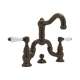 Deck Mount Bridge Lavatory Faucet with Porcelain Levers Pop-Up and Column Spout in Tuscan Brass